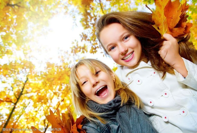 落叶背景开心微笑的姐妹图片