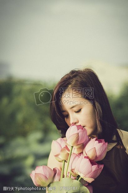 成束花手捧粉色莲花的美丽女孩