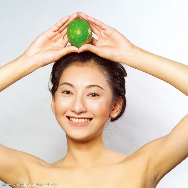 瘦身模特把水果放在头顶上的健康美女图片