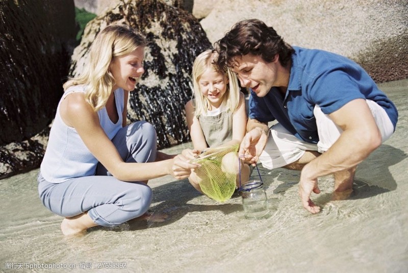 玩耍海边抓鱼的幸福家庭图片