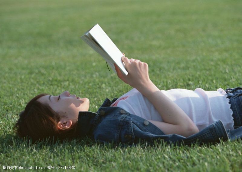 假日休闲女性躺在草地上看书的女人图片