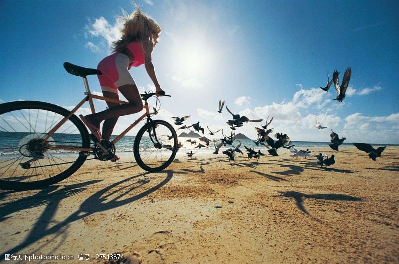 阳光美女沙滩骑自行车的时尚美女图片